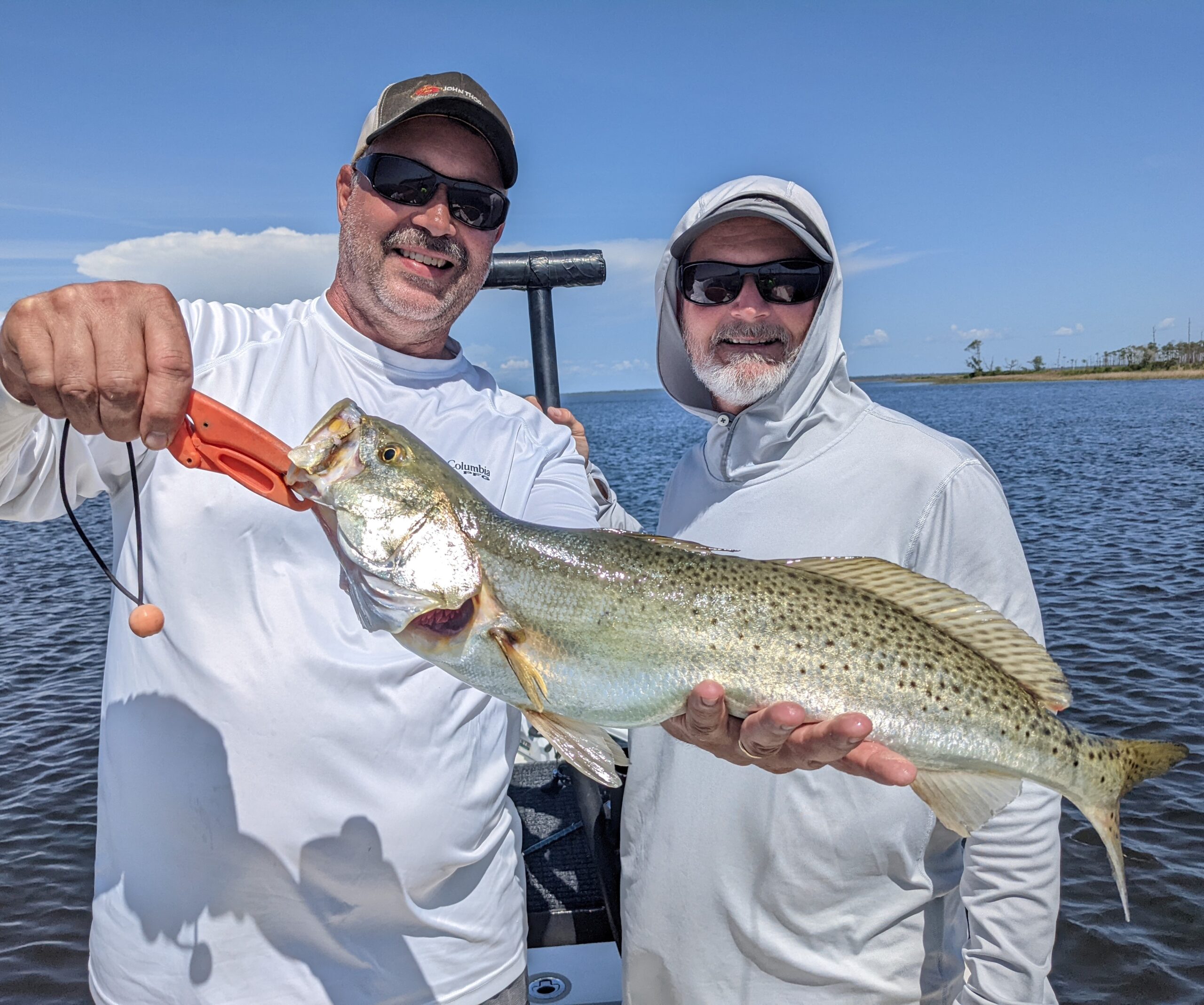 Bay Fishing catch charter fishing client holding a fish and getting some Bay Fishing in at panama city