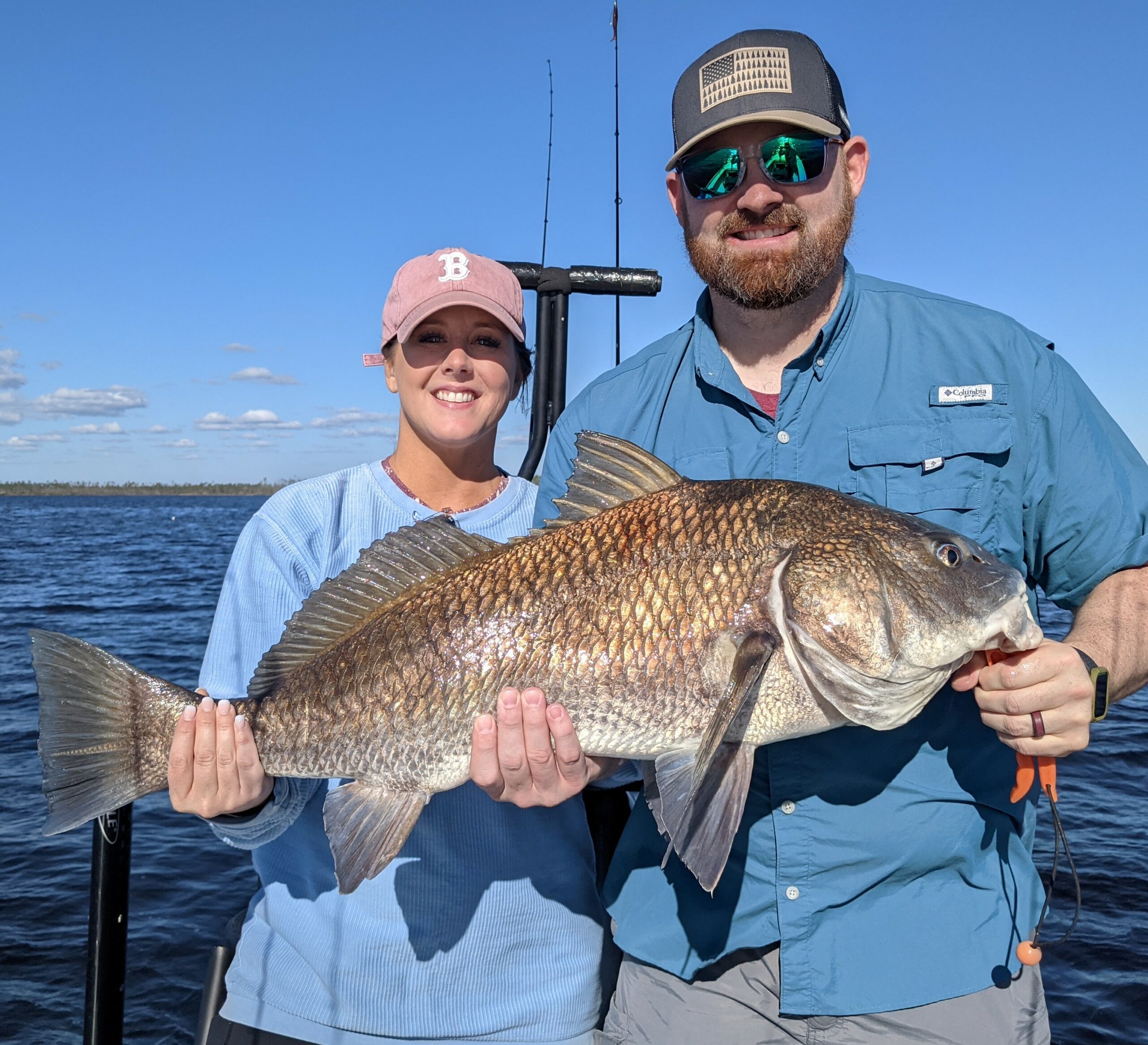 Black Drum Fishing catch charter fishing client holding a fish and getting some Black Drum Fishing in at panama city