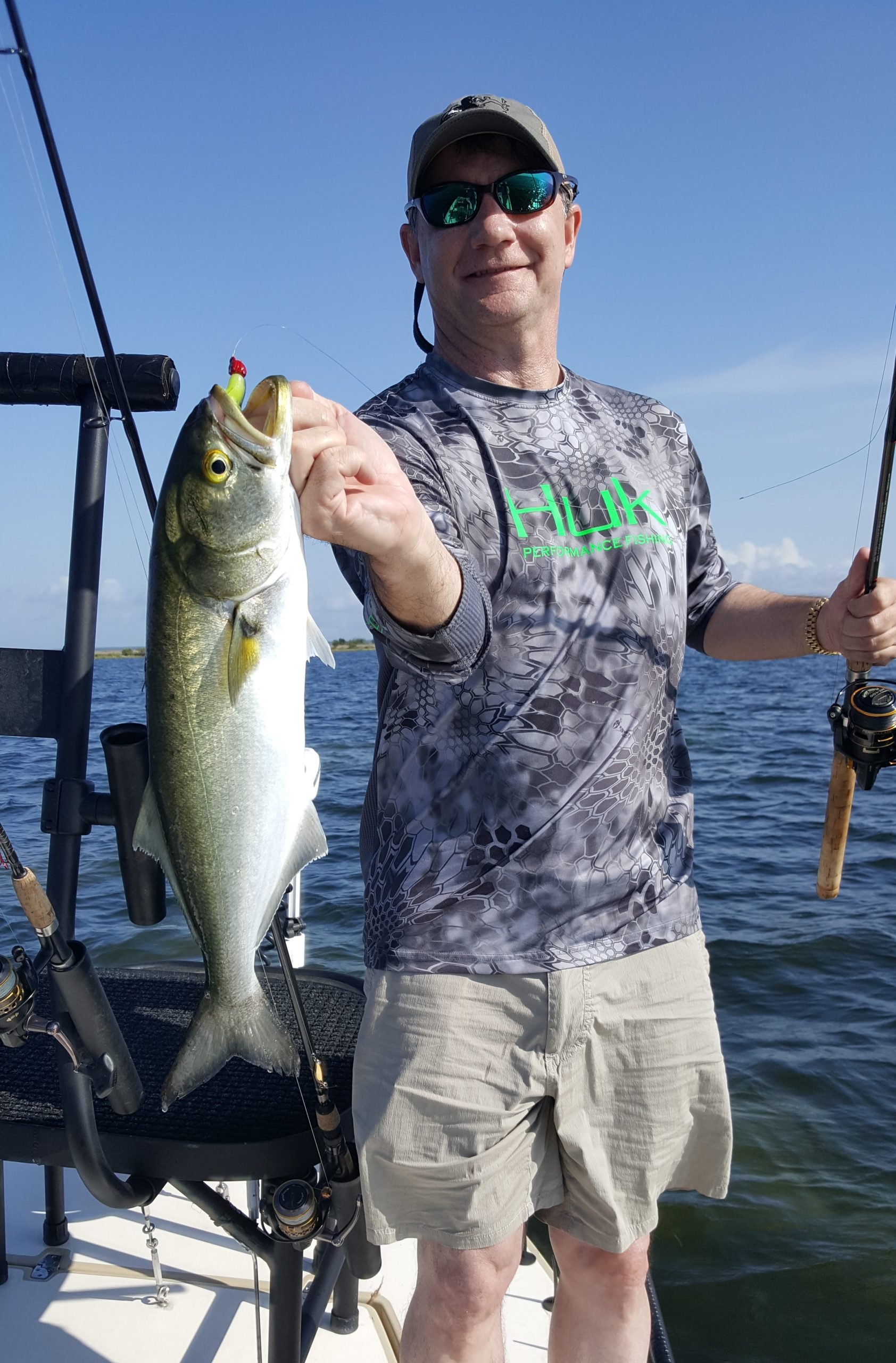 Blue Fishing catch charter fishing client holding a fish and getting some Blue Fishing in at panama city