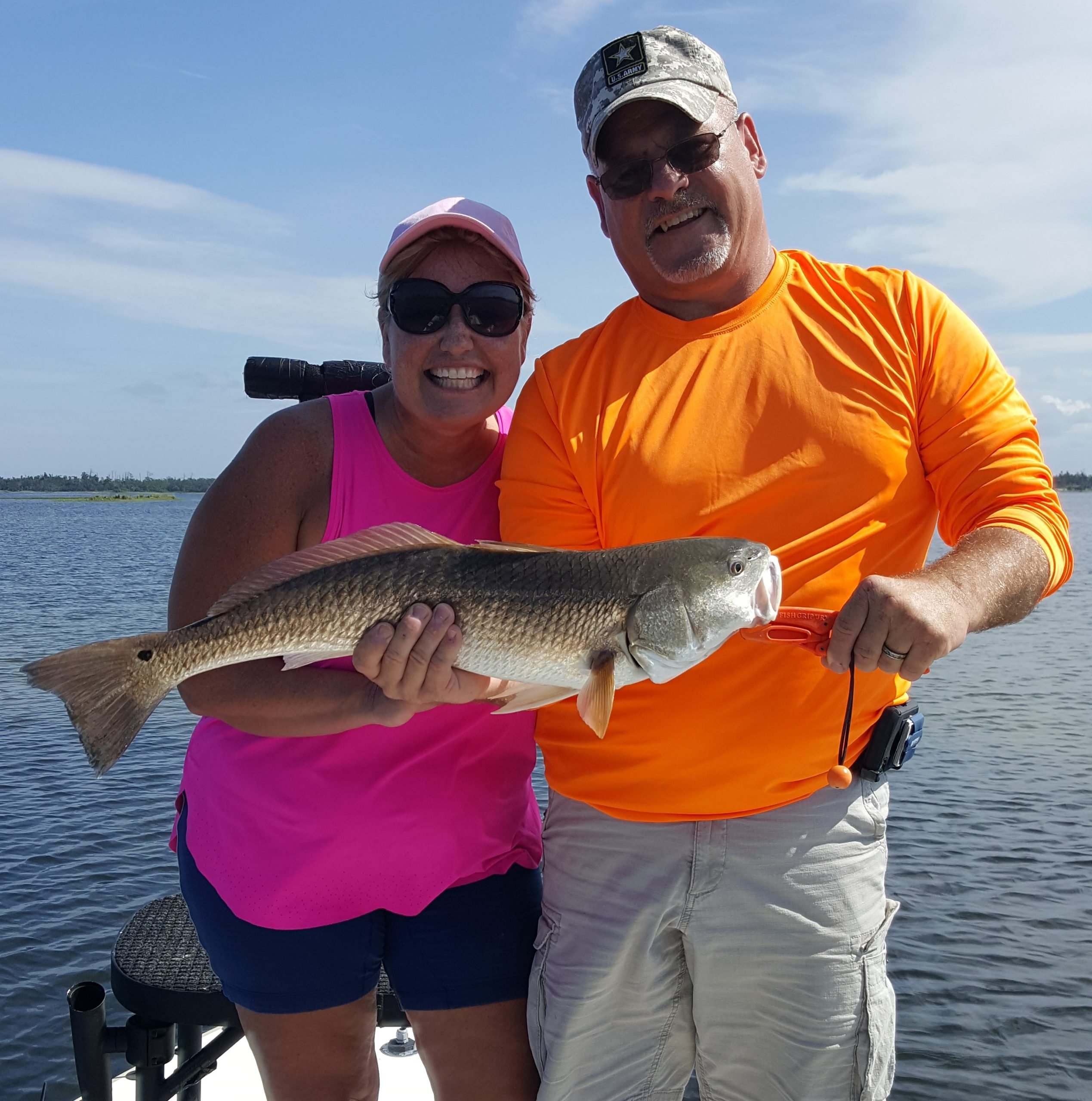 Fall Fishing catch charter fishing client holding a fish and getting some Fall Fishing in at panama city