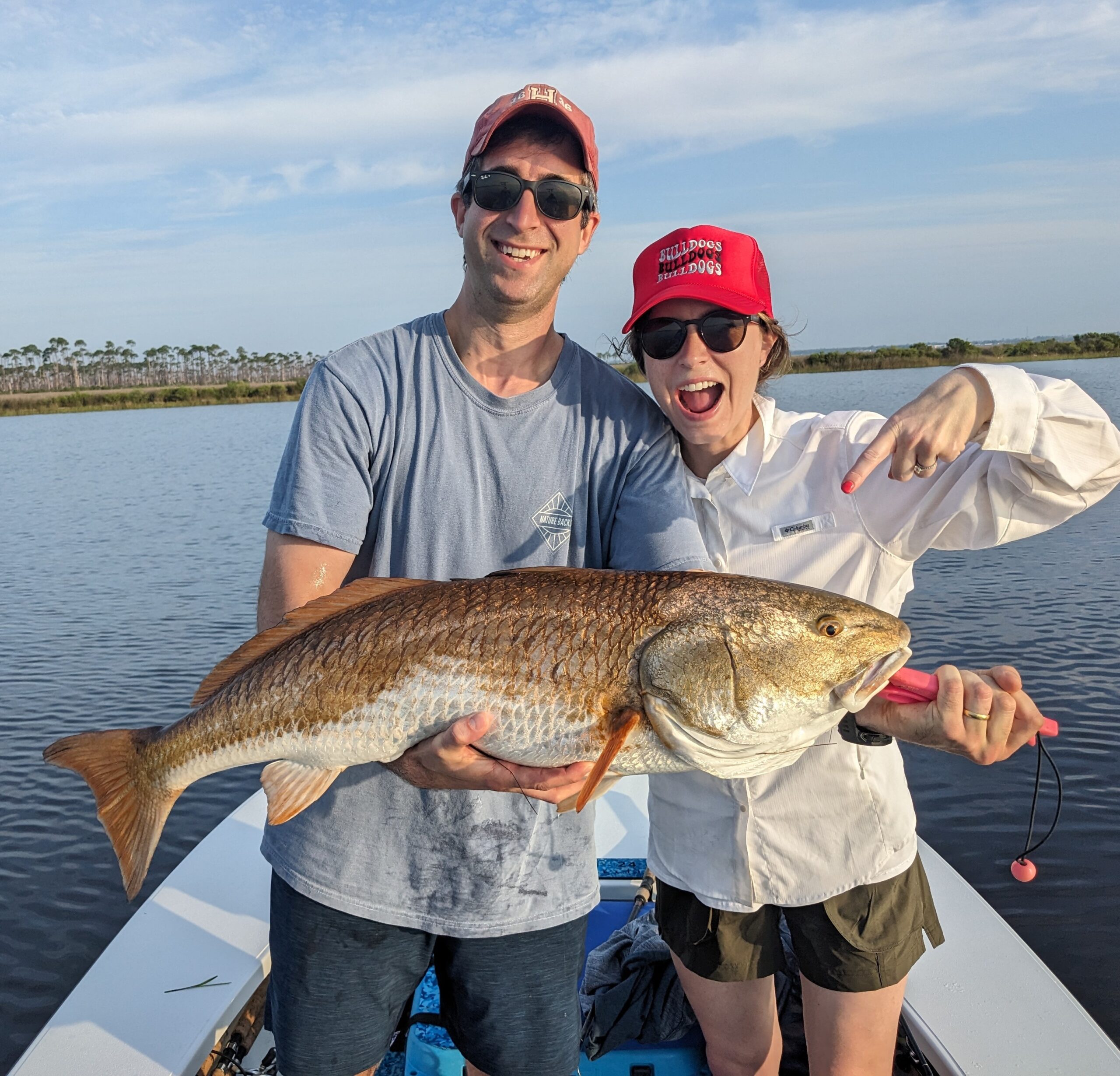 Flats Fishing catch charter fishing client holding a fish and getting some Flats Fishing in at panama city