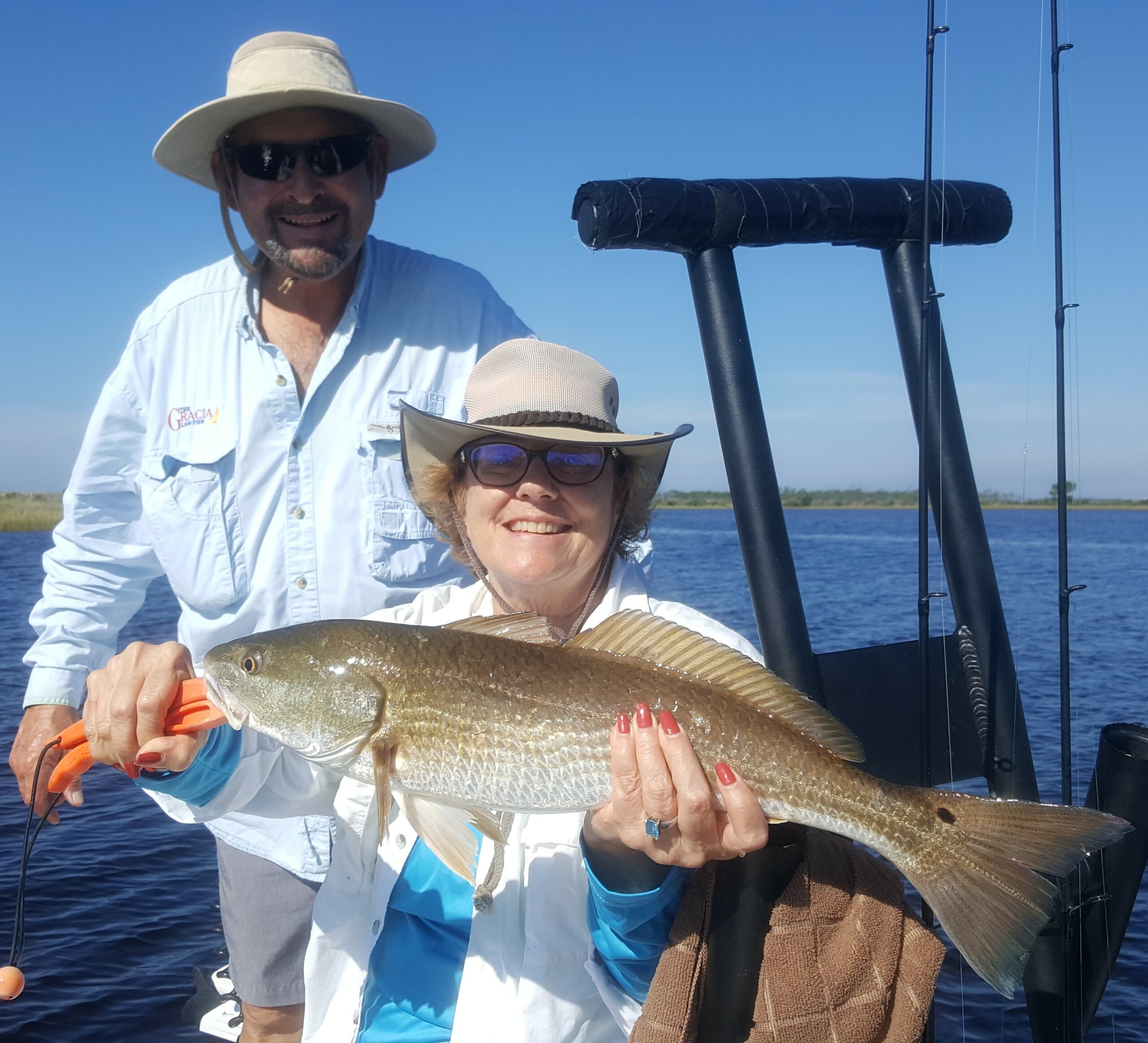 Inshore Fishing catch charter fishing client holding a fish and getting some Inshore Fishing in at panama city