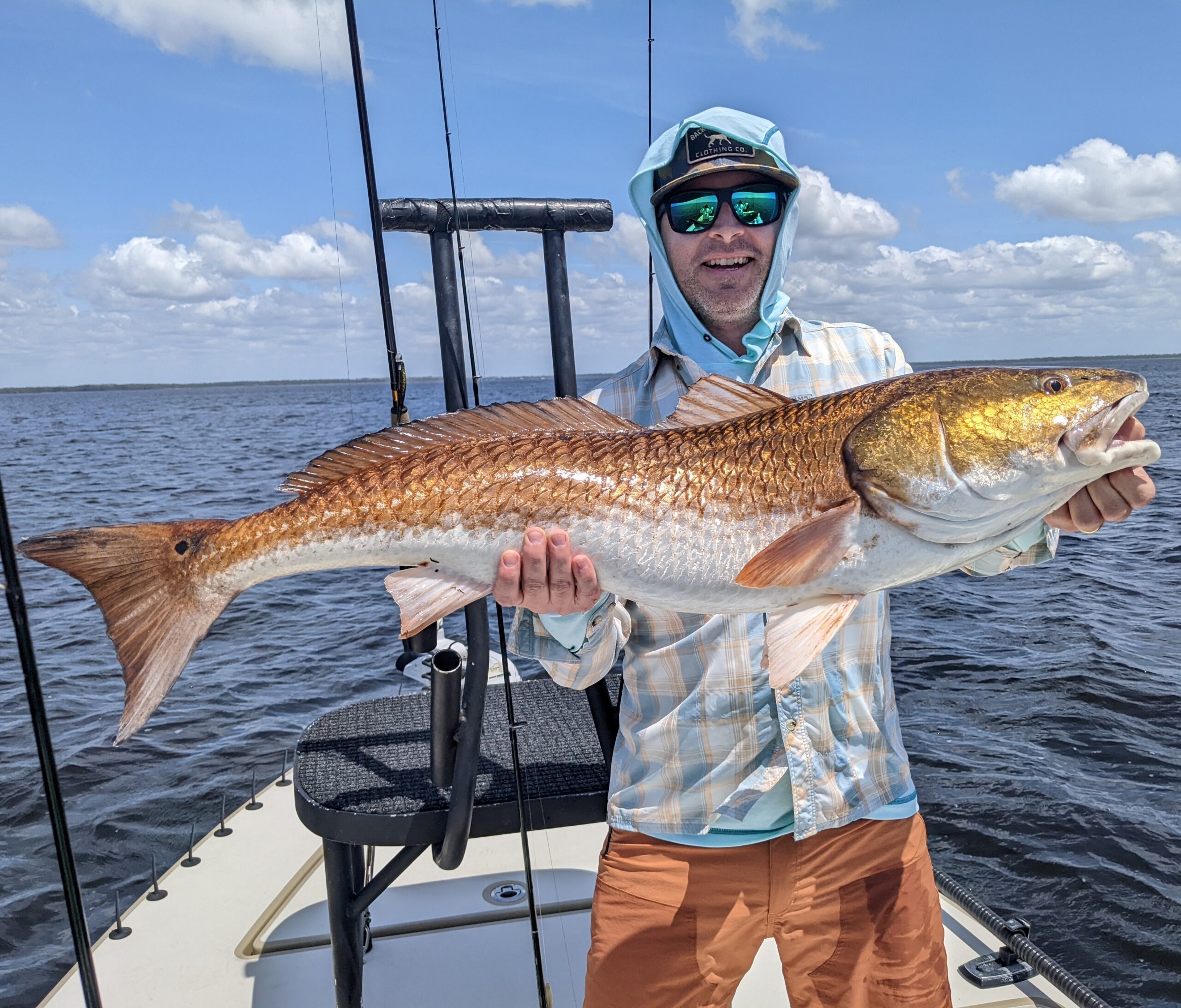 Sight Fishing catch charter fishing client holding a fish and getting some Sight Fishing in at panama city