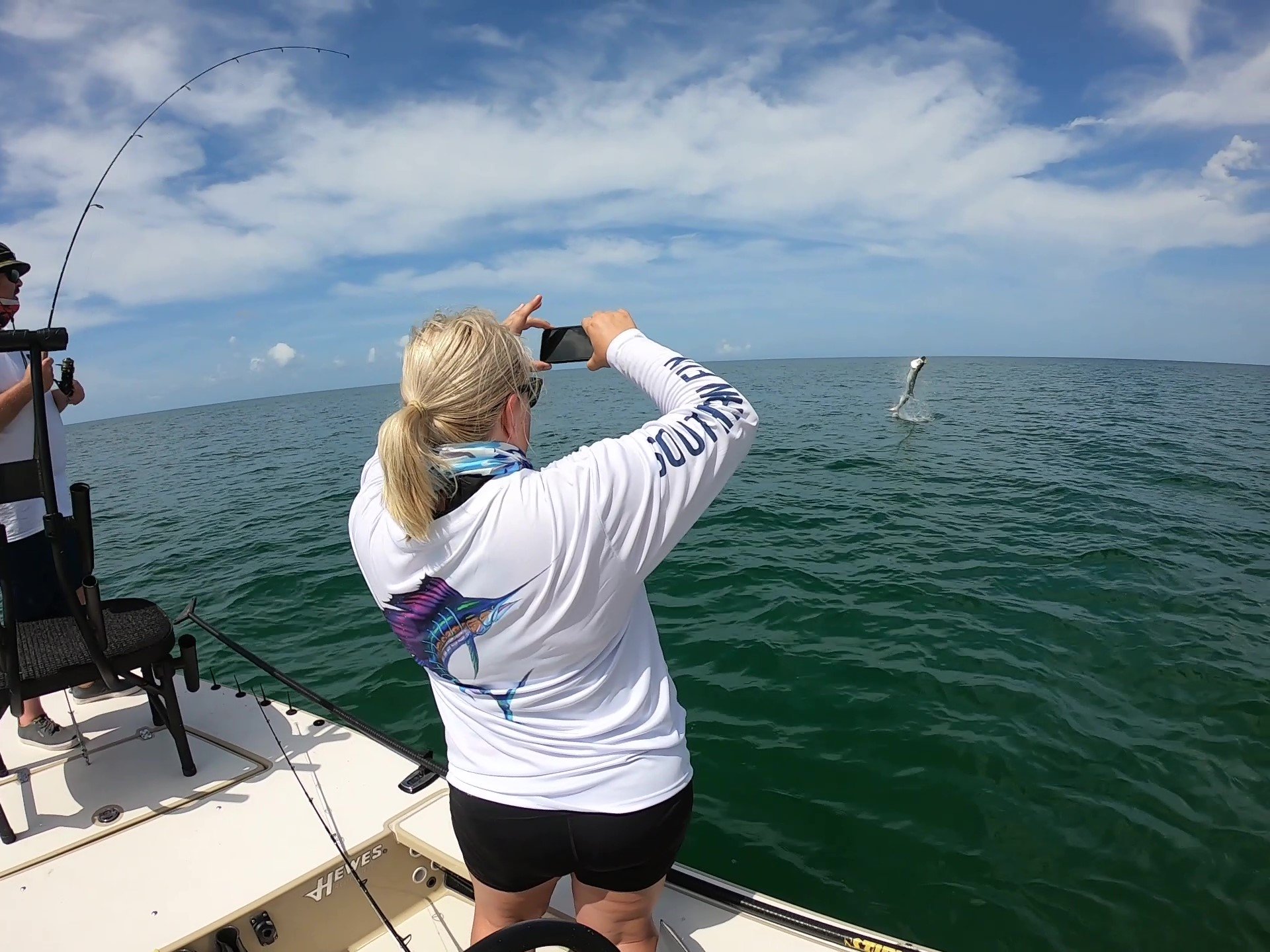 Tarpon Fishing catch charter fishing client holding a fish and getting some Tarpon Fishing in at panama city