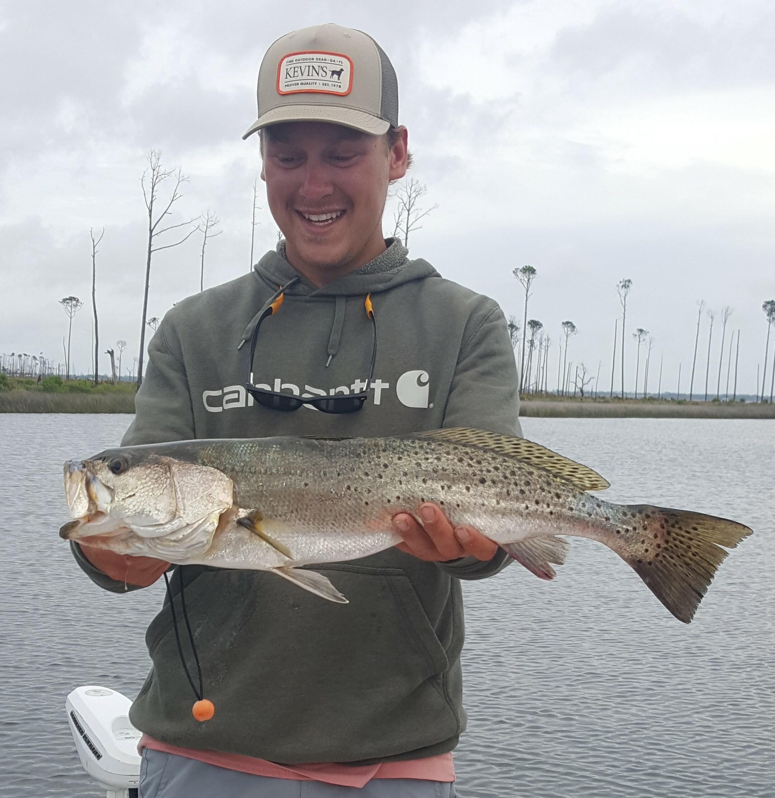 Winter Fishing catch charter fishing client holding a fish and getting some Winter Fishing in at panama city
